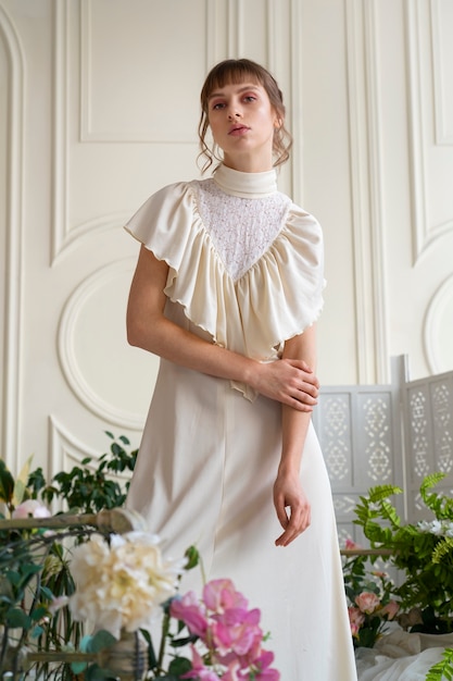 Free Photo portrait of young woman with flowers wearing a boho chic dress