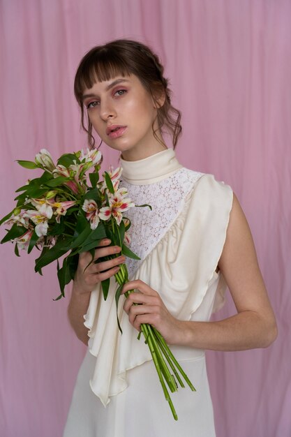 Free photo portrait of young woman with flowers wearing a boho chic dress