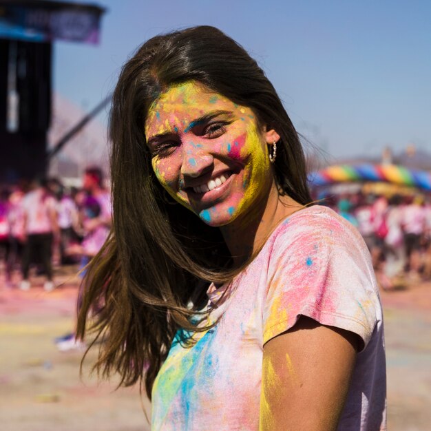 Portrait of a young woman with holi powder