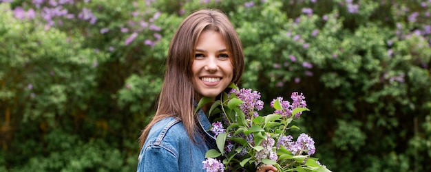 Portrait young woman with lilac branches