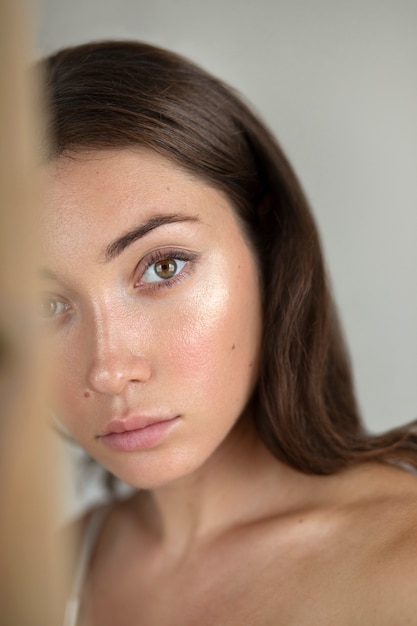 Free Photo portrait of young woman with low self-esteem with mirror