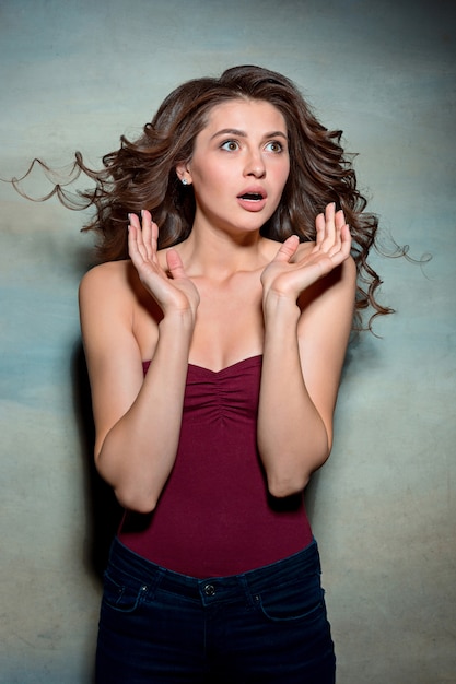 Free photo portrait of young woman with shocked facial expression