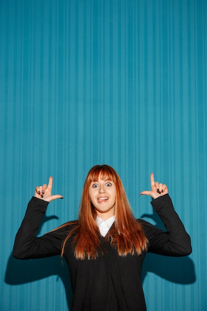 Portrait of young woman with shocked facial expression