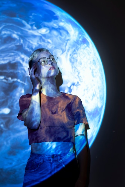 Portrait of young woman with universe projection texture