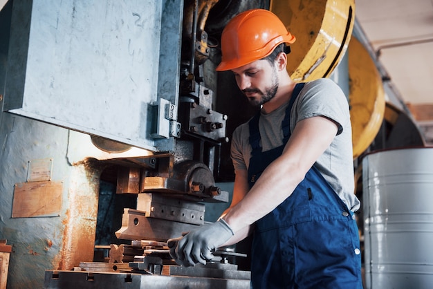 Free Photo portrait of a young worker in a hard hat at a large metalworking plant