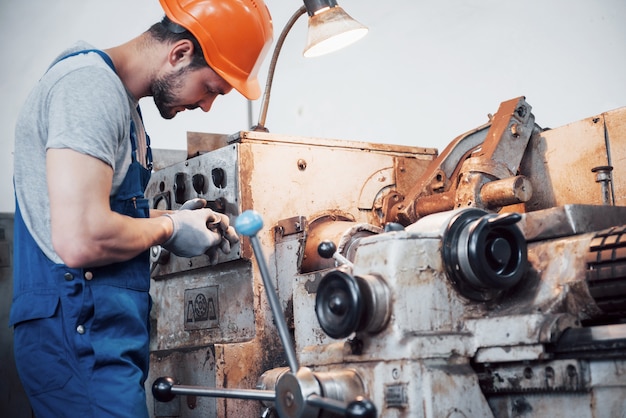 Free Photo portrait of a young worker in a hard hat at a large metalworking plant.