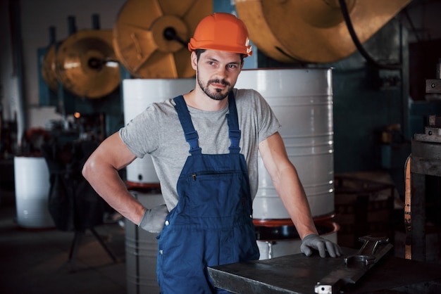 Free Photo portrait of a young worker in a hard hat at a large waste recycling factory.