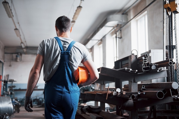 Free photo portrait of a young worker in a hard hat at a large waste recycling factory