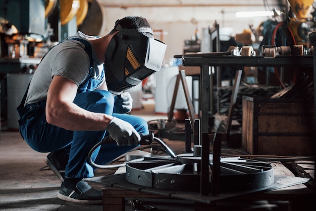 Portrait of a young worker at a large metalworking plant.