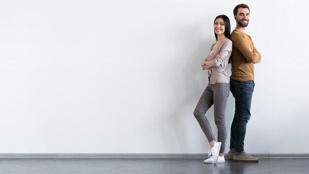 Positive adult male and woman posing with copy space