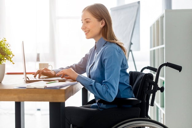 Positive adult woman working at the office