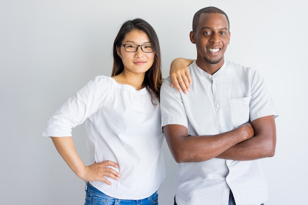 Positive beautiful interracial couple looking at camera. 