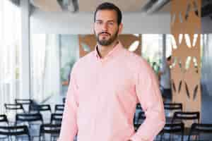 Free photo positive confident business coach posing in training room