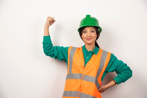 Positive female employee showing her muscles