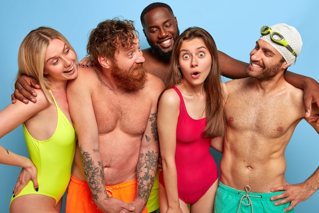 Positive friends posing at the beach