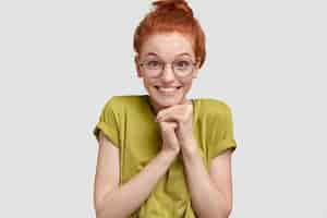 Free photo positive good looking ginger female smiles gladfully