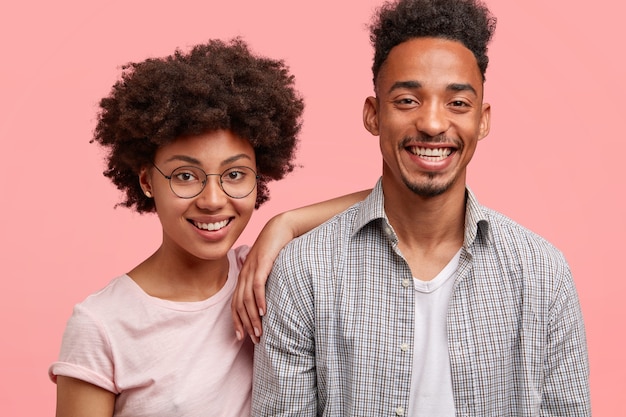 Positive happy young woman and her best man friend, glad to be together, recieve good news