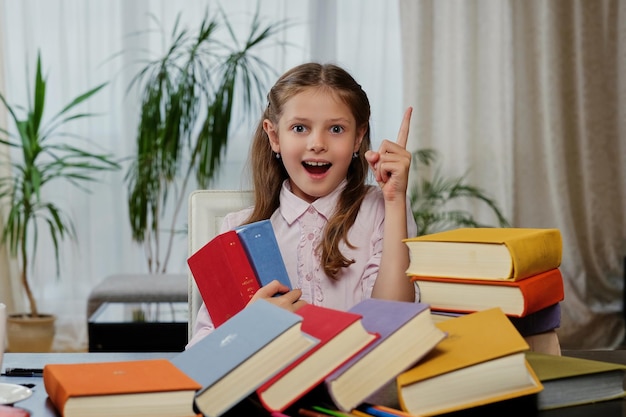 Positive little girl likes reading a lot of books.