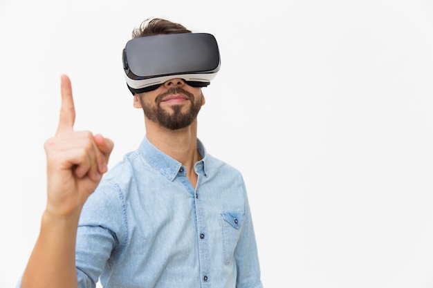 Positive male user wearing VR glasses, having idea