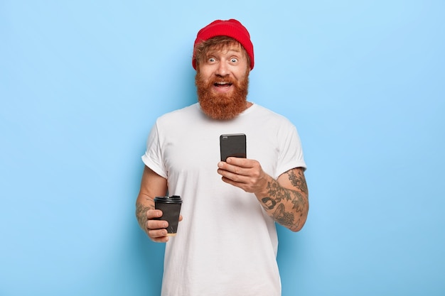 Positive millennial boy happy to get message from girlfriend, types answer