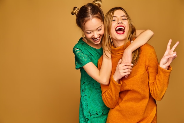 Free photo positive models posing with their dresses