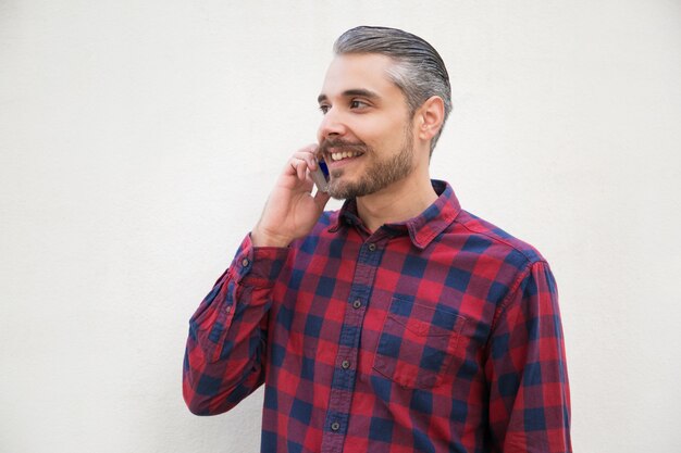 Positive satisfied man speaking on cell