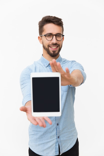 Positive smiling tablet user showing blank screen