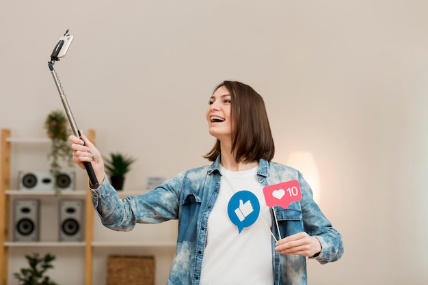 Positive woman recording video at home