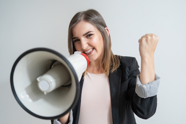 Free photo positive young caucasian woman with megaphone showing success