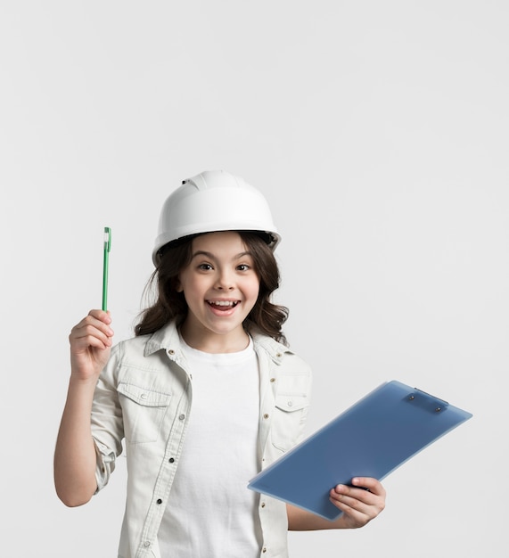 Free photo positive young girl holding clipboard