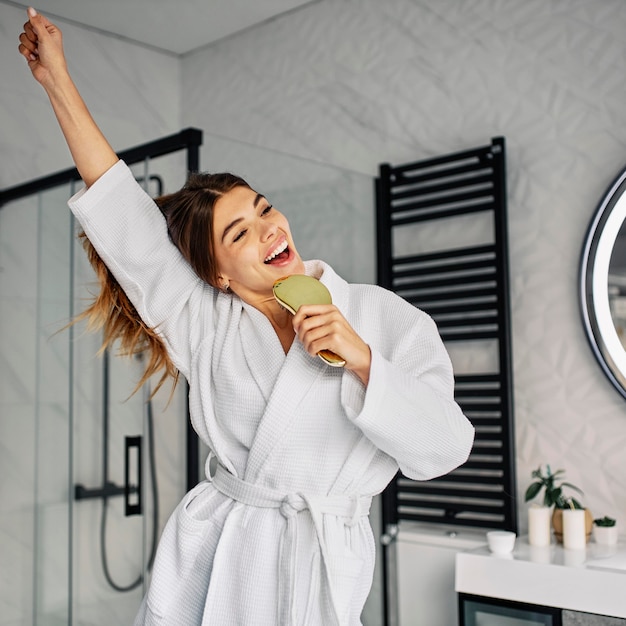 Free photo positive young woman in a bathrobe