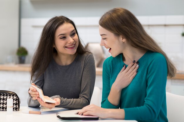 Positive young women happy with make-up accessories