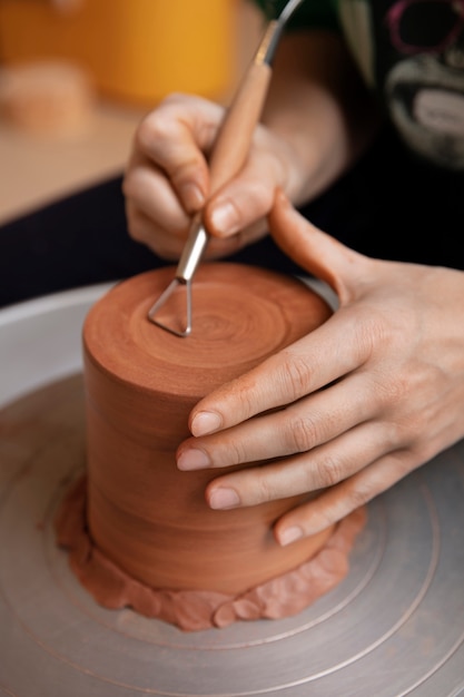 Free photo pottery craftsperson in the studio creating ceramics