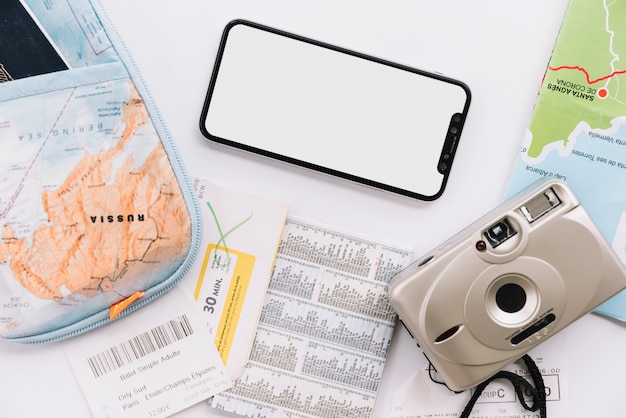 Free Photo pouch; map; digital camera and blank screen cell phone on white background