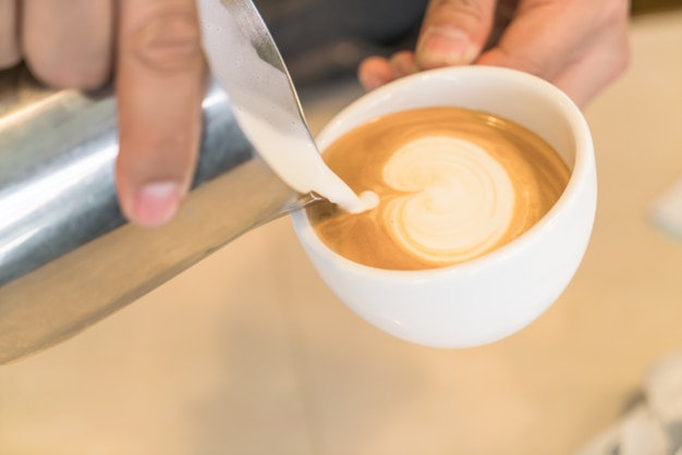 Pouring milk to mix Latte Coffee art