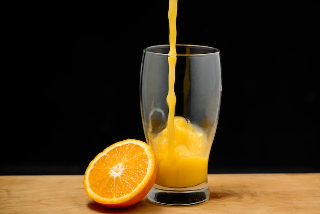 Pouring orange juice into glass Copy space