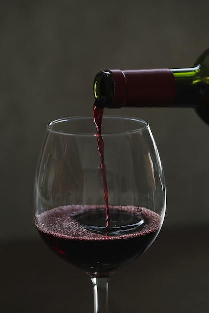 Pouring red wine in glass