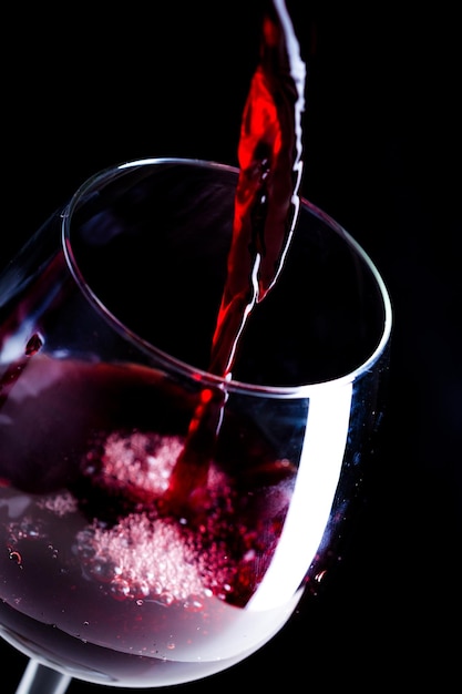 Free photo pouring red wine into the glass