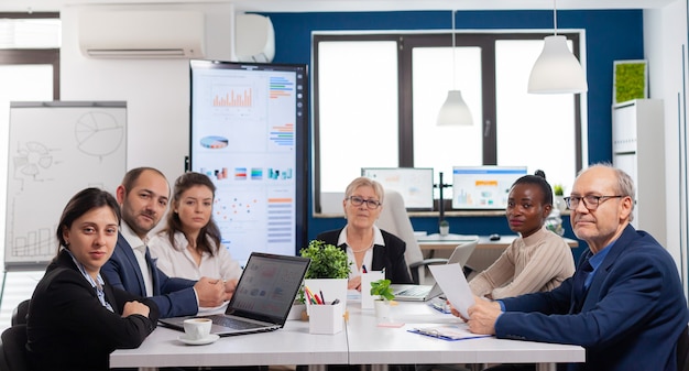 Free Photo pov of diverse team sitting in conference room during virtual meeting, discussing online with business partners