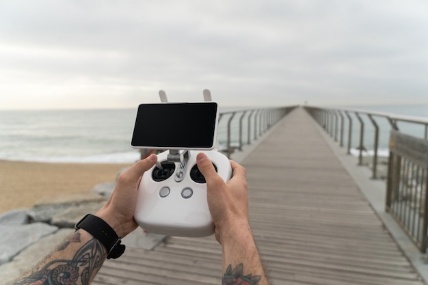 POV shot of hipster and millennial new generation user of futuristic new technologies, use drone remote control to fly device in air.