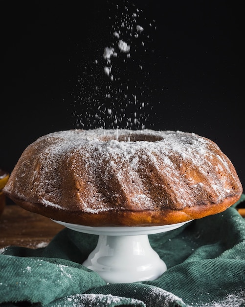 Powder sugar pouring on cake