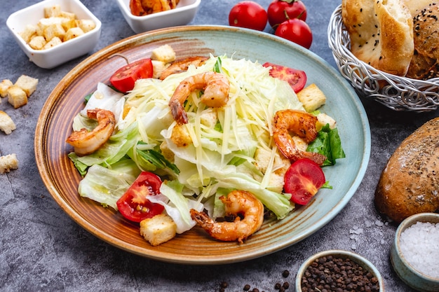 Prawn caesar salad with lettuce bread stuffing cherry tomato and parmesan