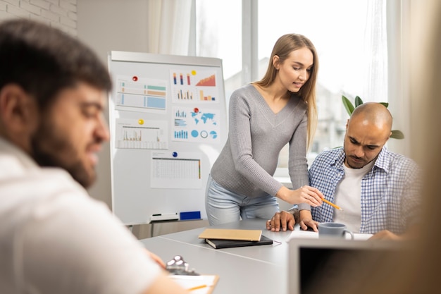 Free photo pregnant businesswoman with male coworkers during a presentation