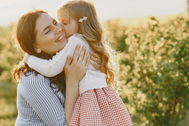 Pregnant mother with her daughter in a field