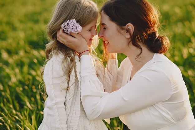 Pregnant mother with her daughter in a field