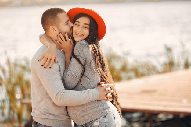 Pregnant wife with her husband standing near river