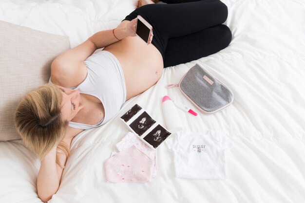 Pregnant woman on bed with x rays