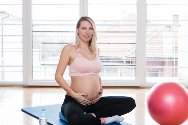 Pregnant woman in fitness studio