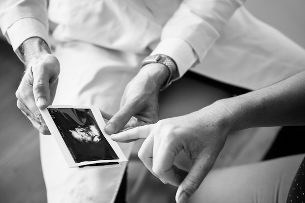 Free Photo pregnant woman having fetal monitoring by doctor