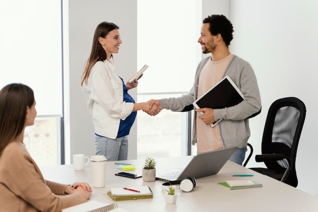 Pregnant woman having a meeting with her coworker